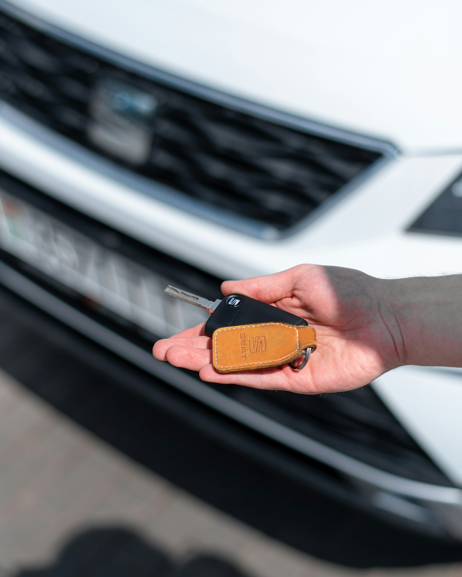 A person holding a car key